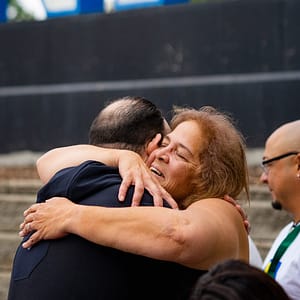 Two individuals hugging